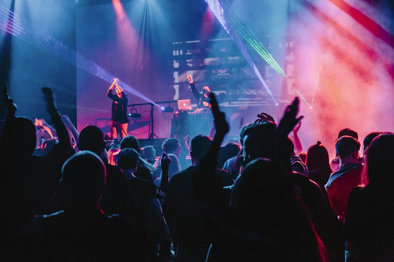 Stage lighting beams over crowd